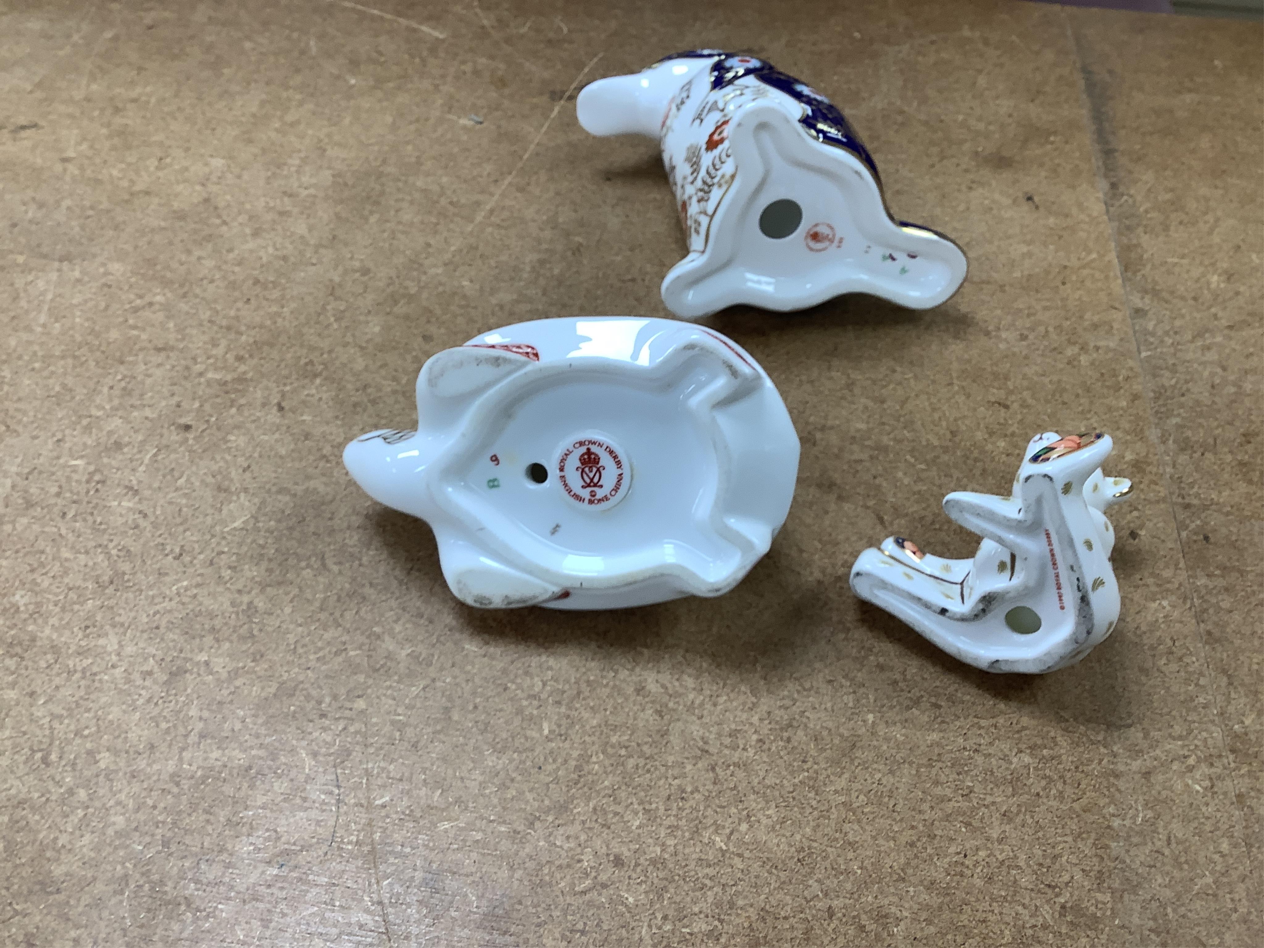 A collection of Royal Crown Derby Imari pattern paperweights, to include penguin and badger, together with three Doulton flambé animals, largest 19cm wide
